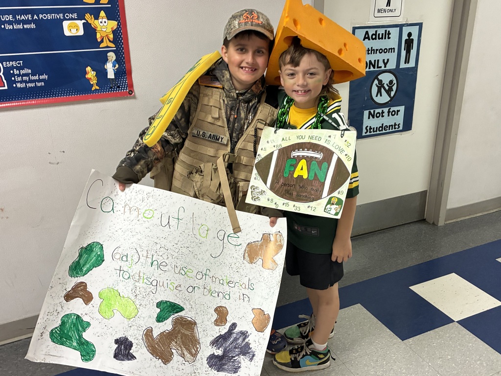Students with vocabulary words jand dressed to illustrate the word . 