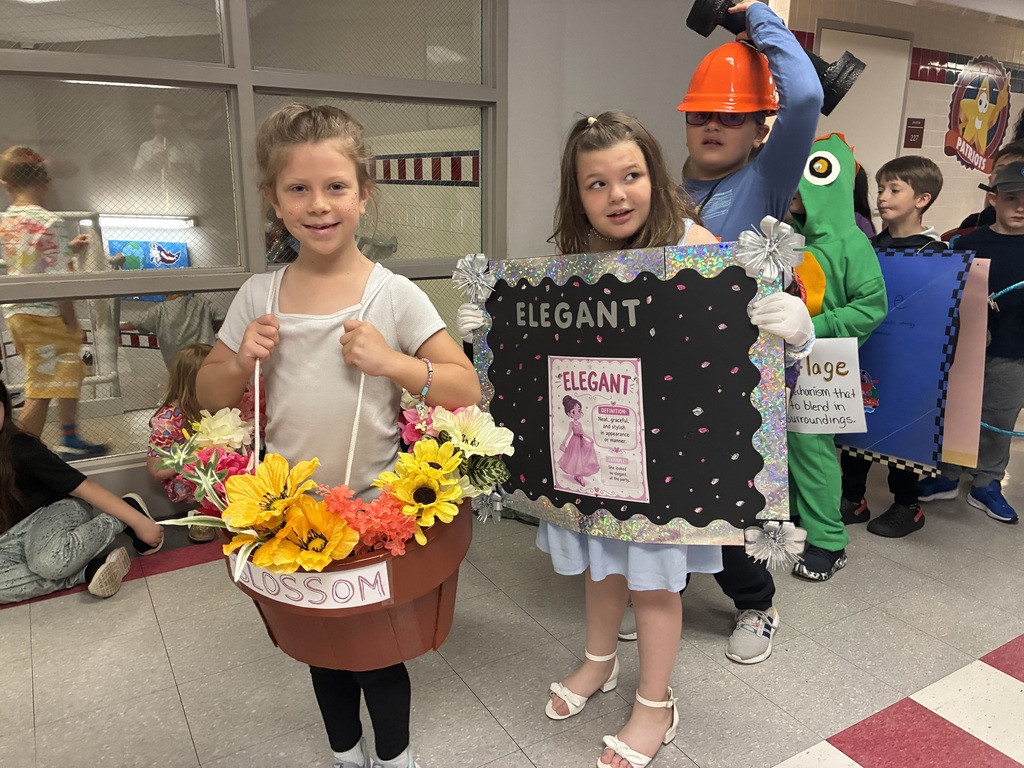 Students with vocabulary words jand dressed to illustrate the word . 