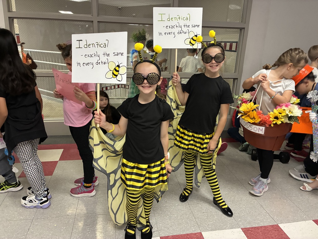 Students with vocabulary words jand dressed to illustrate the word . 
