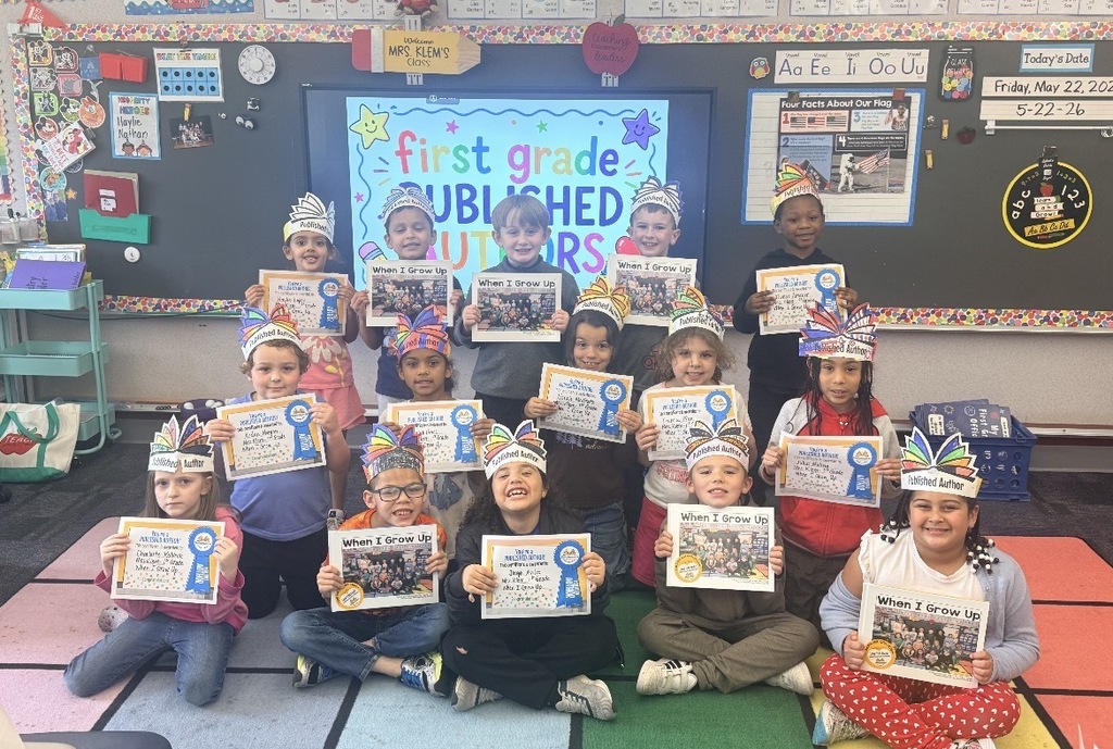 Mrs. Klem’s class in a group posing with their published book. 