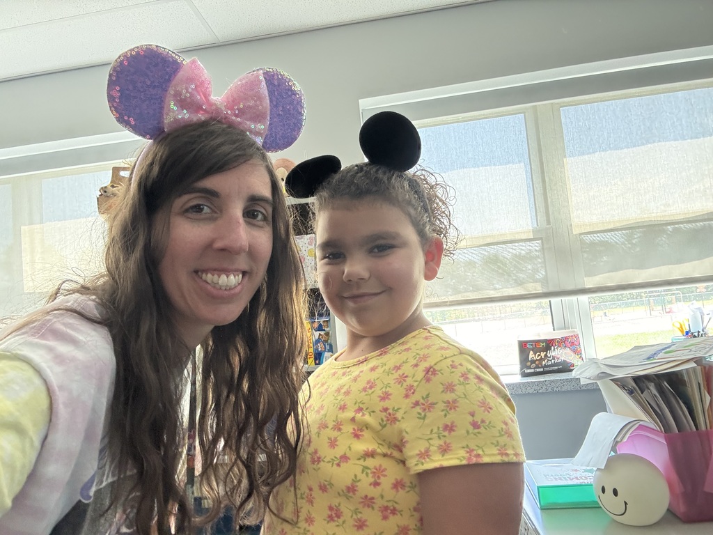 A teacher and girl with mickey ears