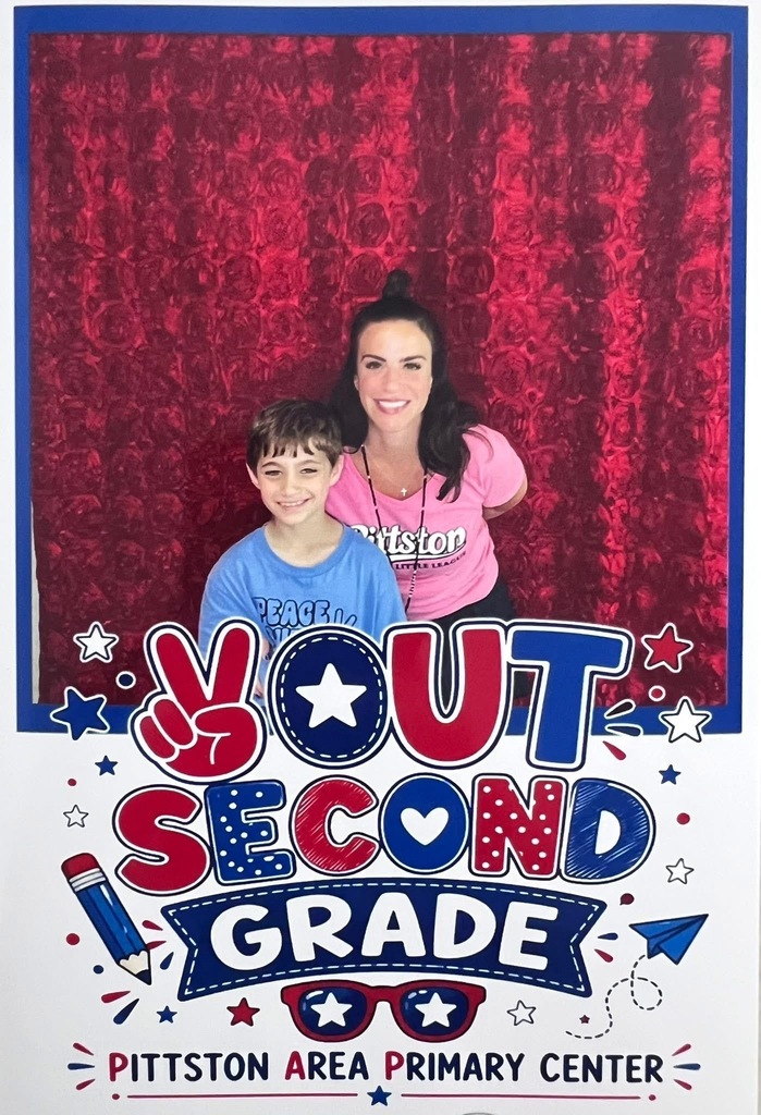 2nd grade student and teacher in the gym at a peace out second grade party