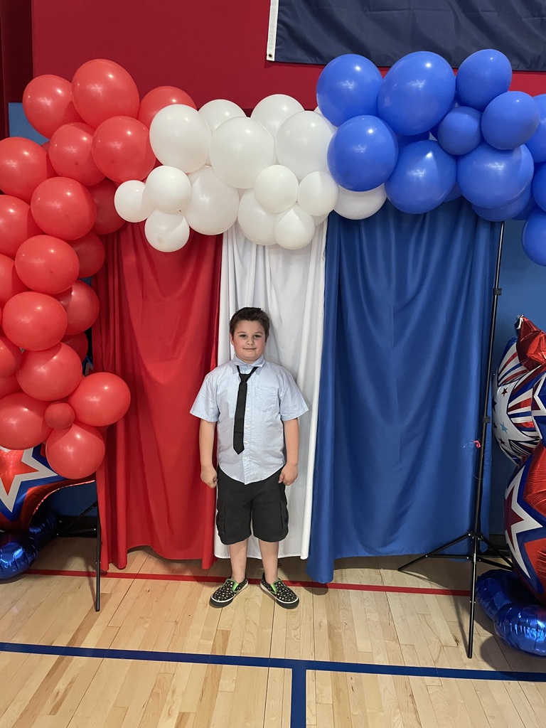 2nd grade students in the gym at a peace out second grade party