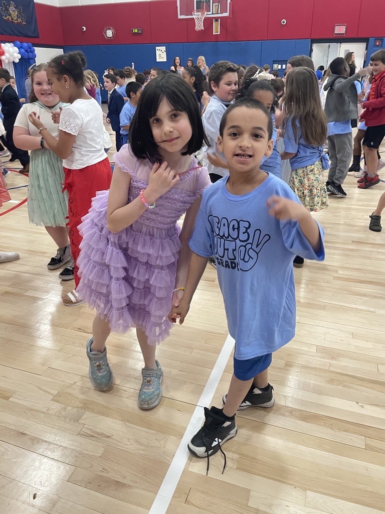 2nd grade students in the gym at a peace out second grade party