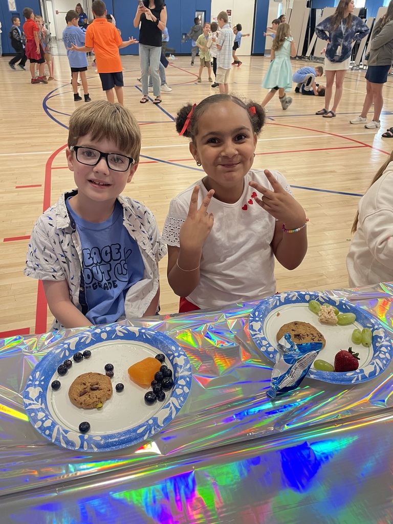 2nd grade students in the gym at a peace out second grade party