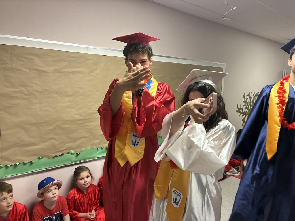 High schools students in the primary center hallways greeted by students and teachers  