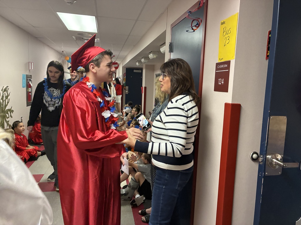 High schools students in the primary center hallways greeted by students and teachers  