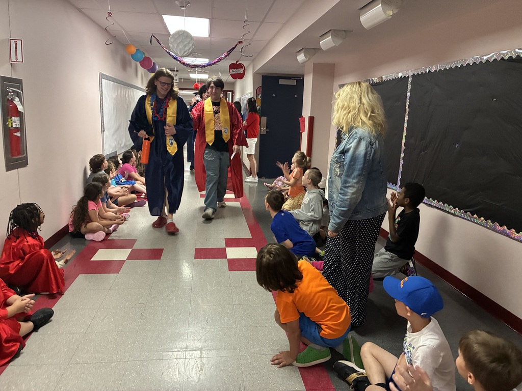 High schools students in the primary center hallways greeted by students and teachers  