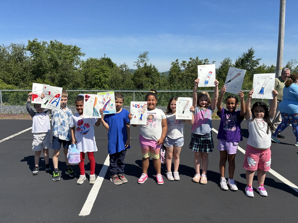 Primary center students outside cheering on the baseball team  