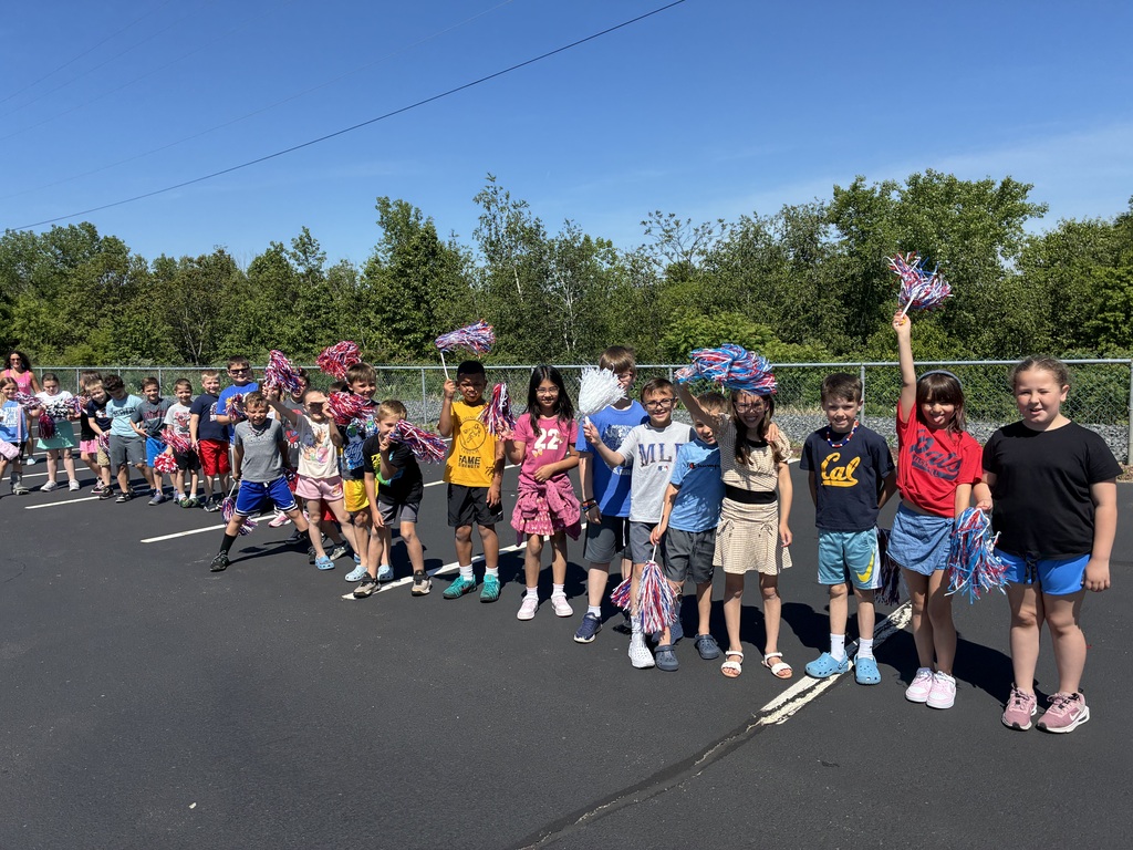 Primary center students outside cheering on the baseball team  