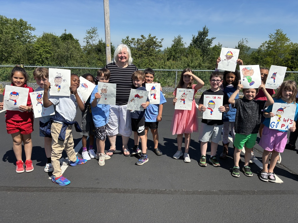 Primary center students outside cheering on the baseball team  