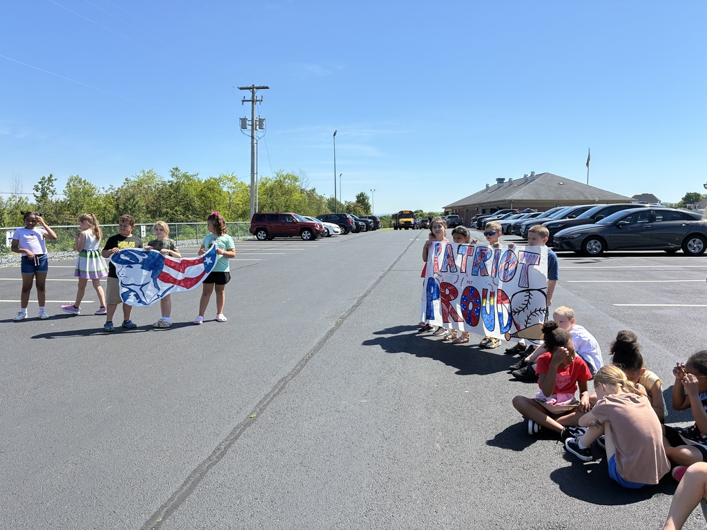 Primary center students outside cheering on the baseball team  