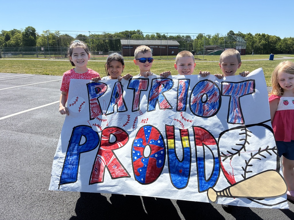 Primary center students outside cheering on the baseball team  