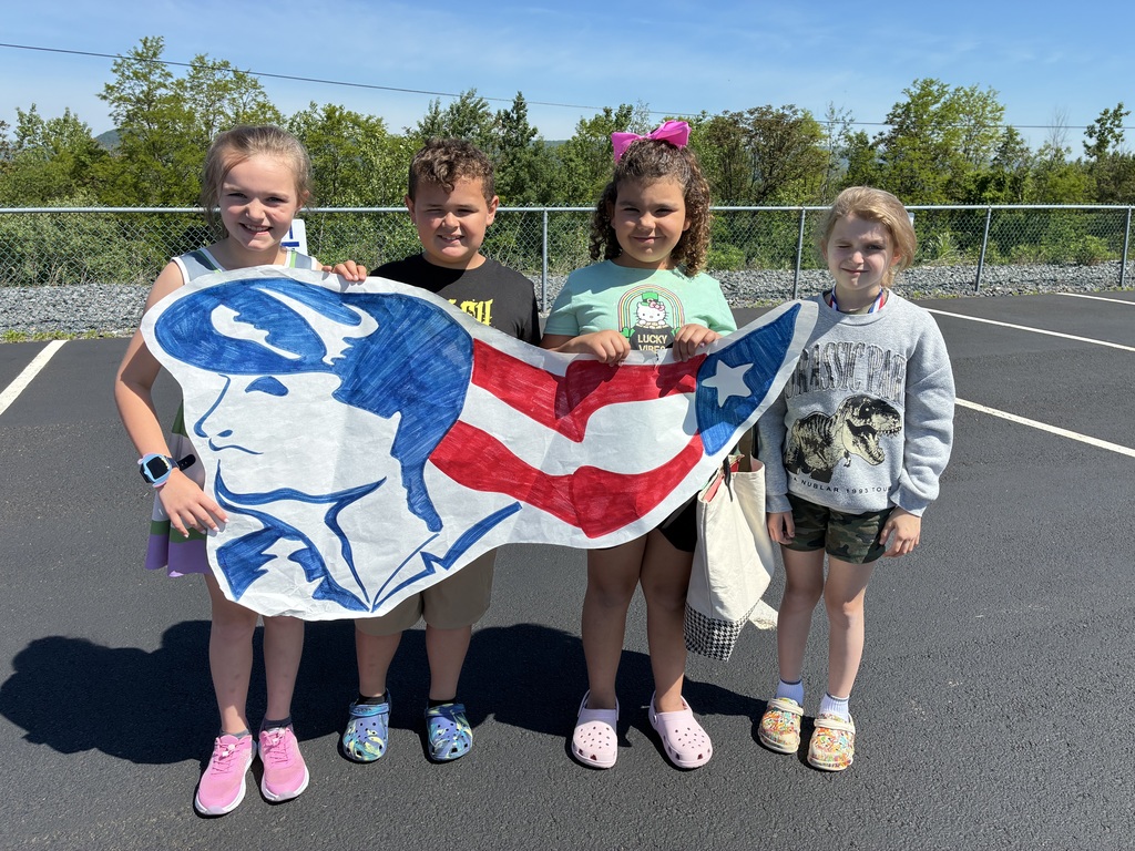 Primary center students outside cheering on the baseball team  