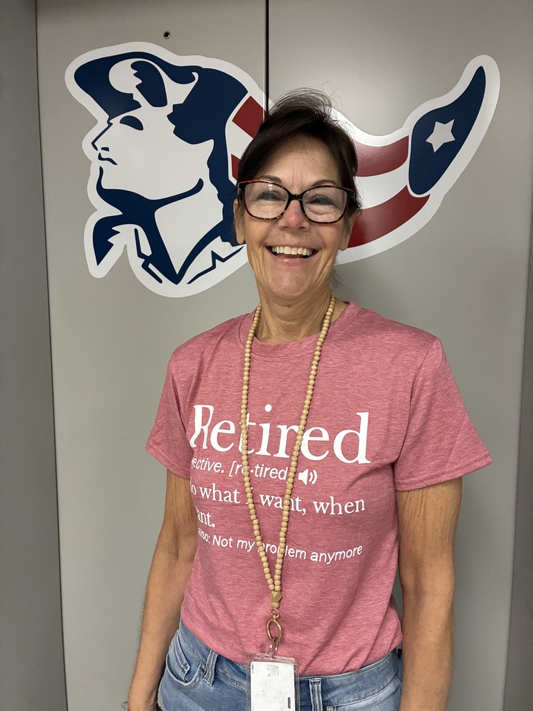 Sue falcone infront of the patriot logo 
