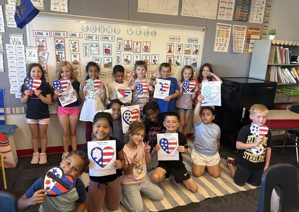 Students holding flag shaped hearts