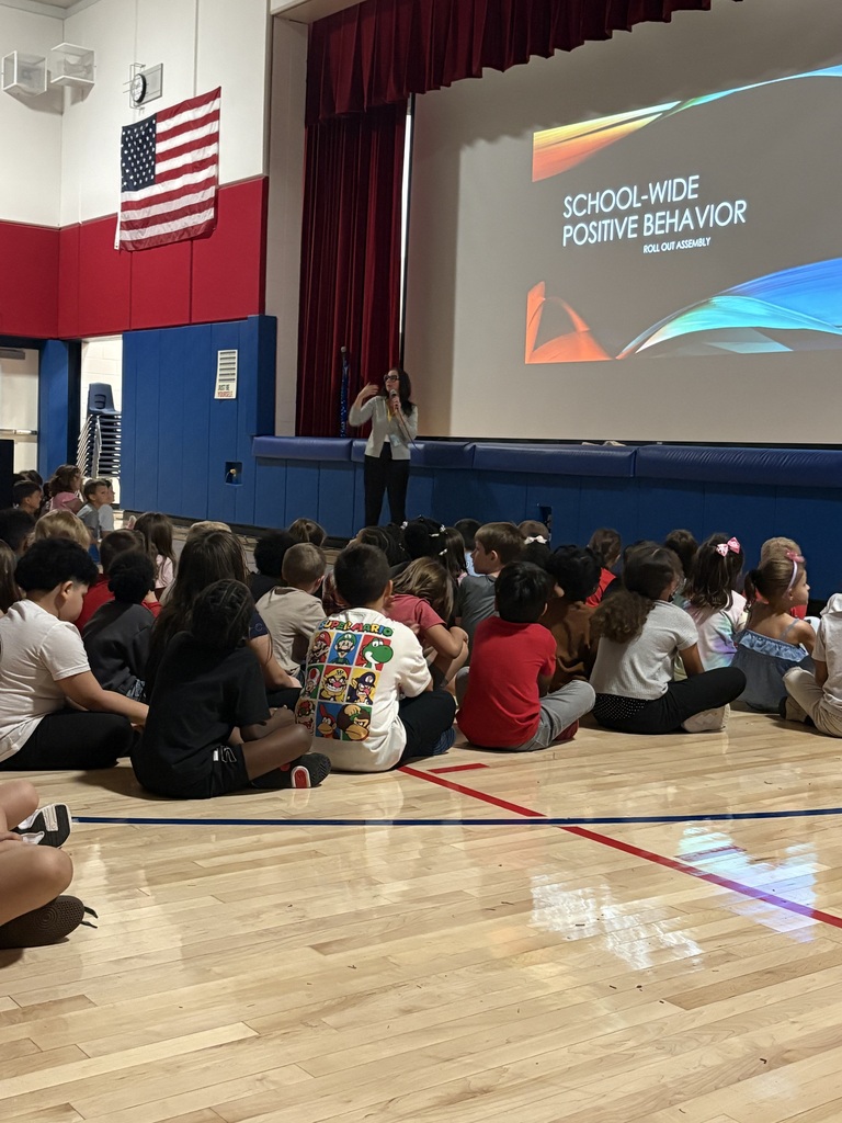 Students in the gym at a star assembly