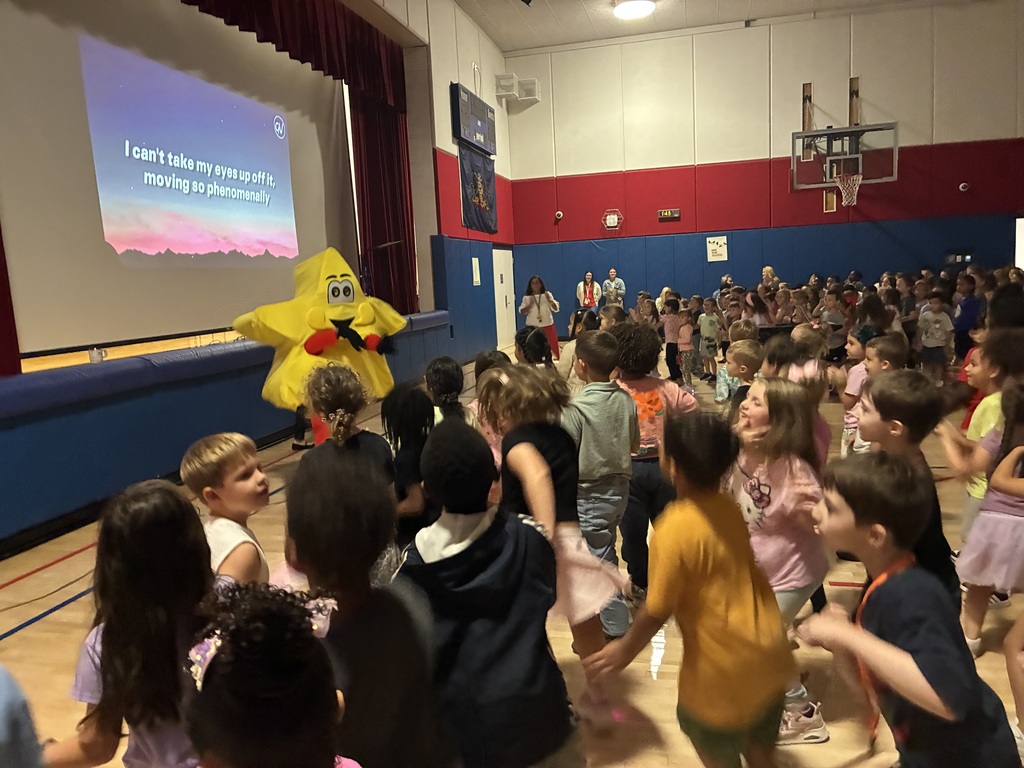 Students in the gym at a star assembly