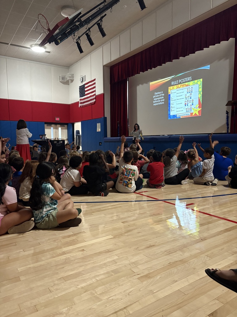 Students in the gym at a star assembly