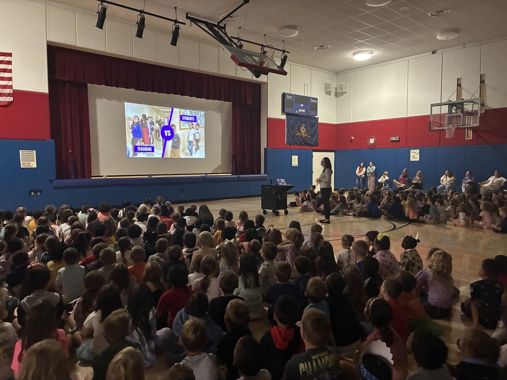 Students in the gym at a star assembly