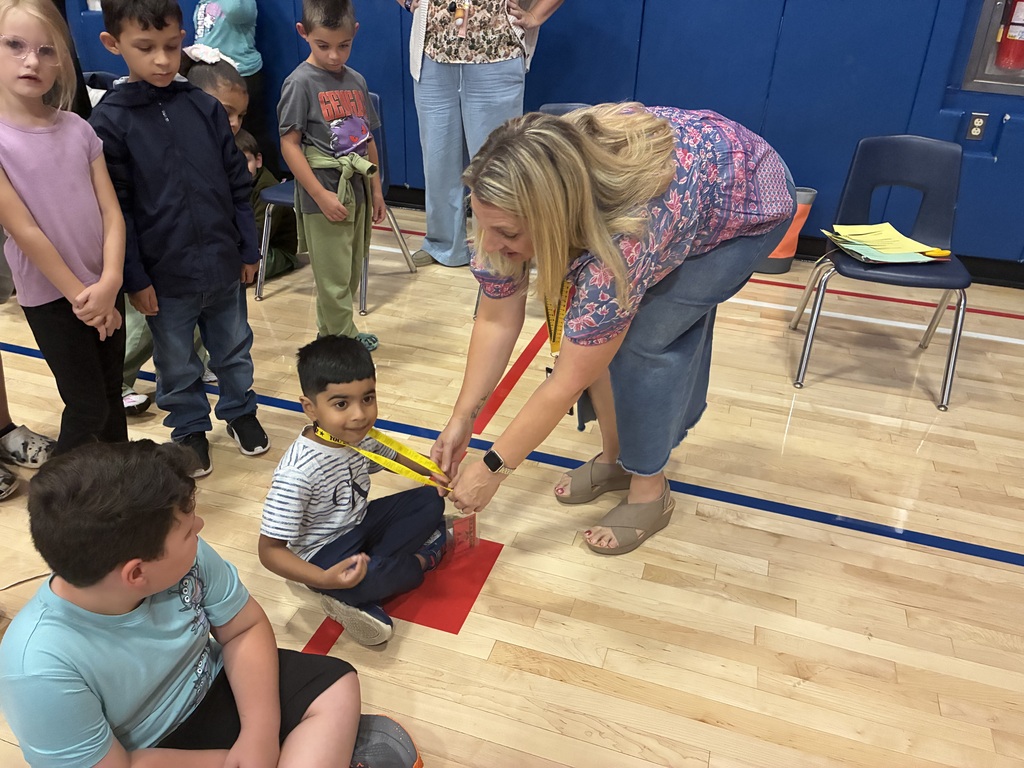 Students in the gym at a star assembly