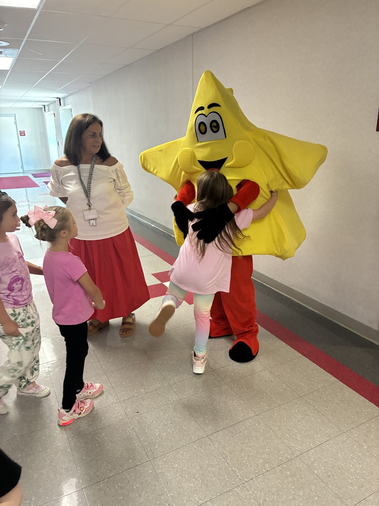Students in the gym at a star assembly