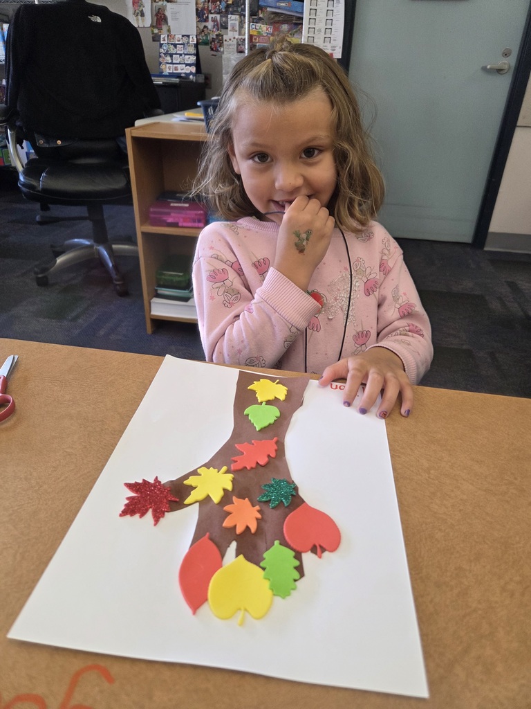 Students with a fall tree collage