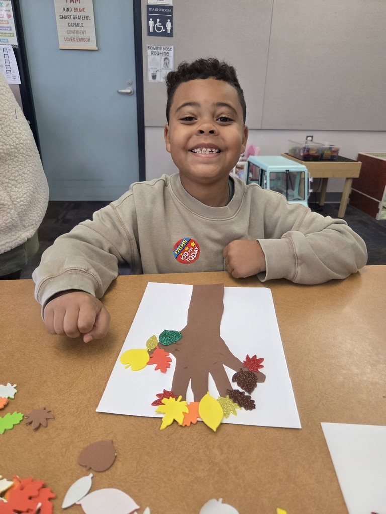 Students with a fall tree collage