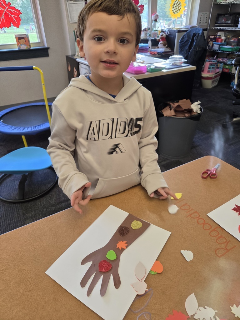 Students with a fall tree collage