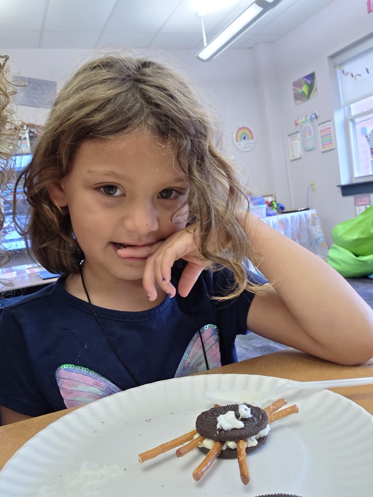 A girl with a spider cookie