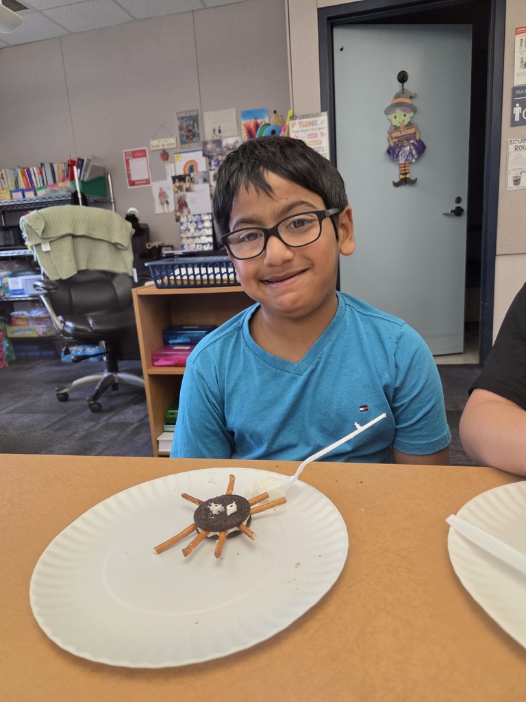 A student making a spider cookie