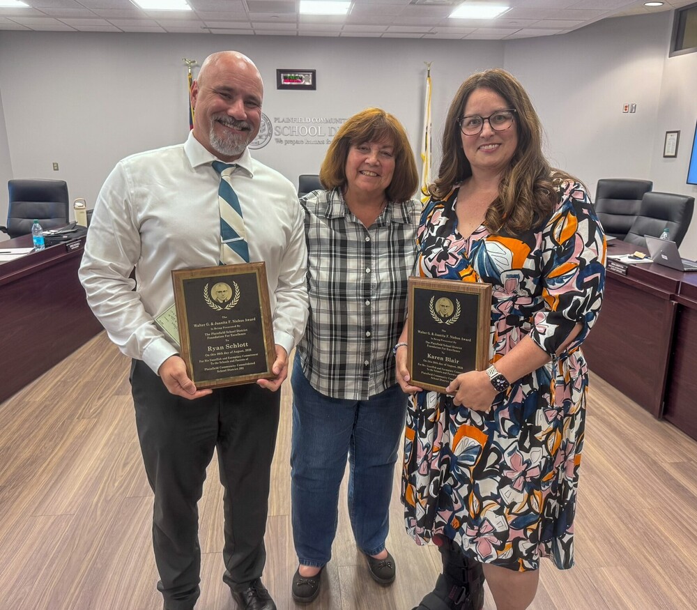 Ira Jones Middle School music teacher Karen Blair (right) and District 202 Director of Technology Ryan Schlott (left) receive the 2026 Niehus Award during the District 202 Board of Education meeting on Wednesday, Aug. 26, 2026.