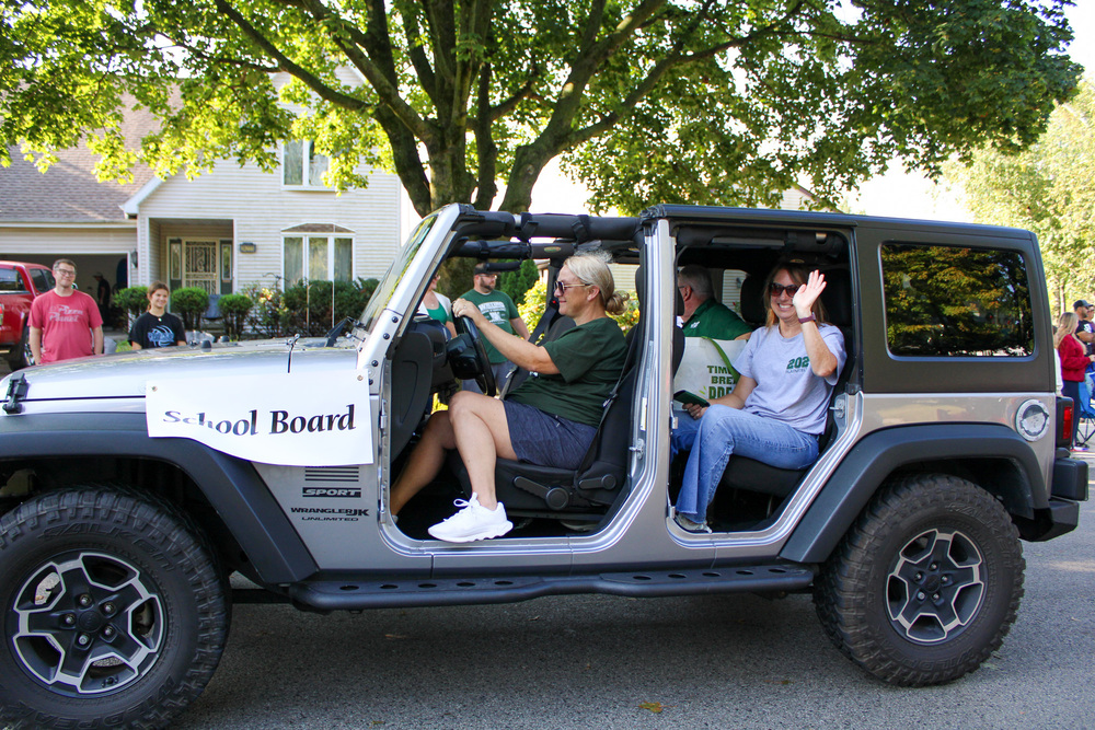 group of people riding in open door jeep in parade