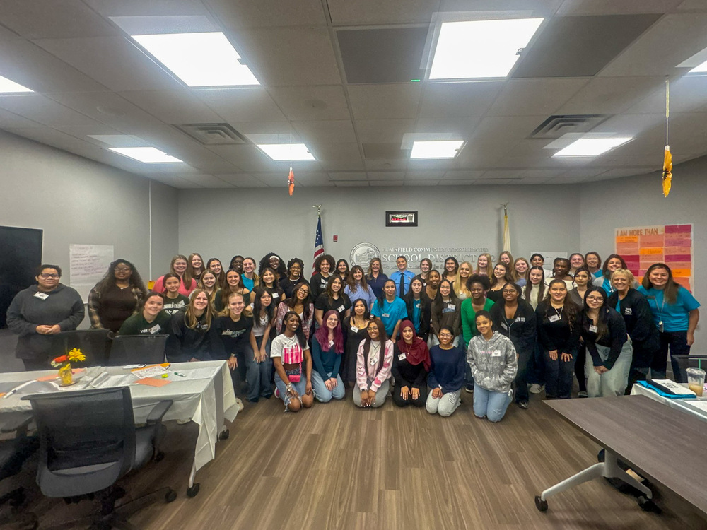 group of female students and women pose for photo