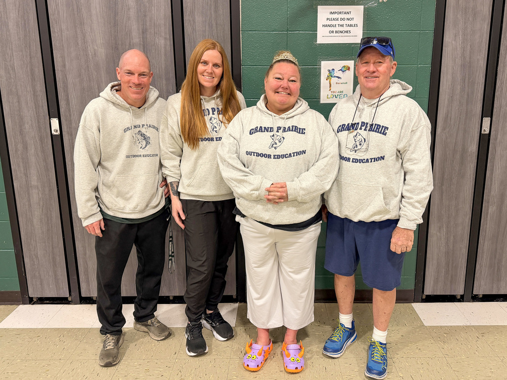 the Grand Prairie physical education team poses for photot in gym