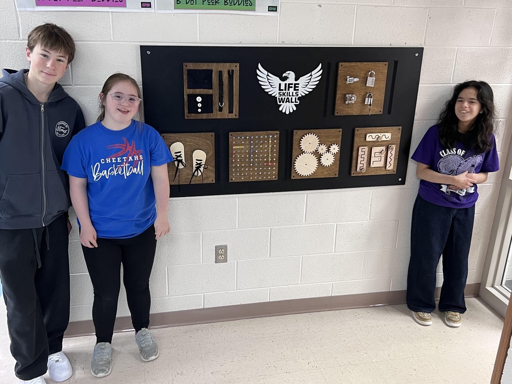 IJMS students stand near new sensory board