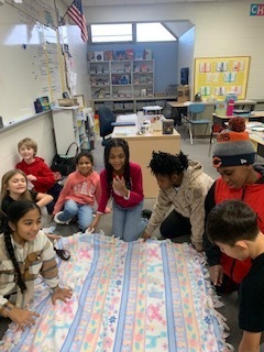 students making no sew blankets