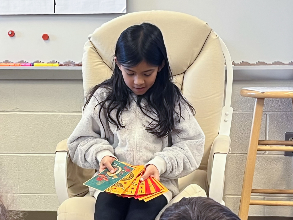 girl sitting and fanning out Chinese New Year cards