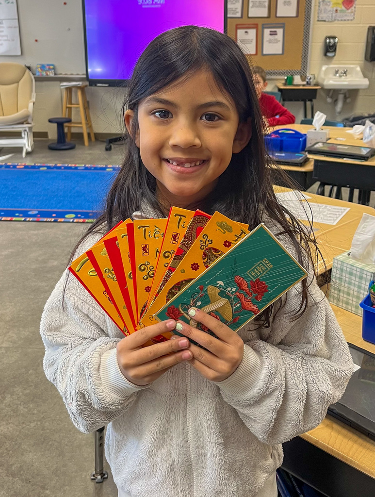 girl standing and holding Chinese New Year cards