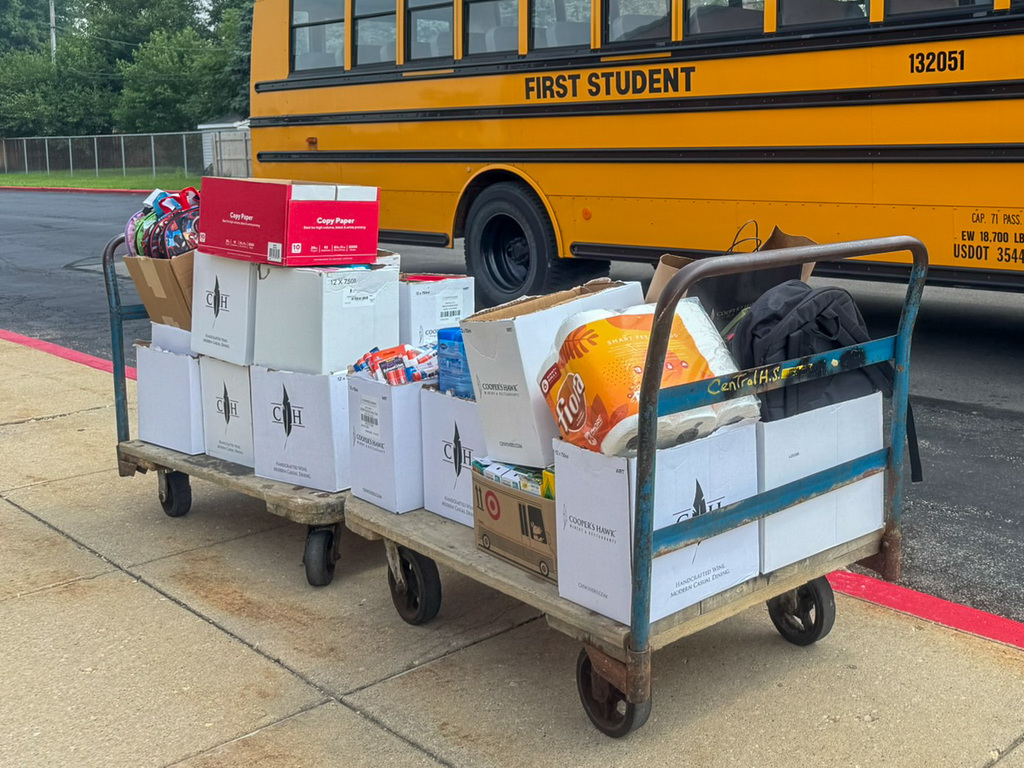 Two carts full of boxes of school supplies