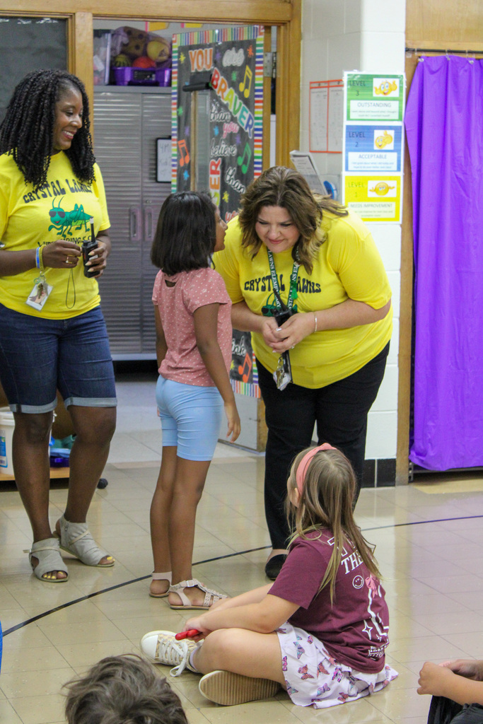 student whispers in principals' ear