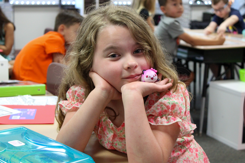 girl holding toy poses