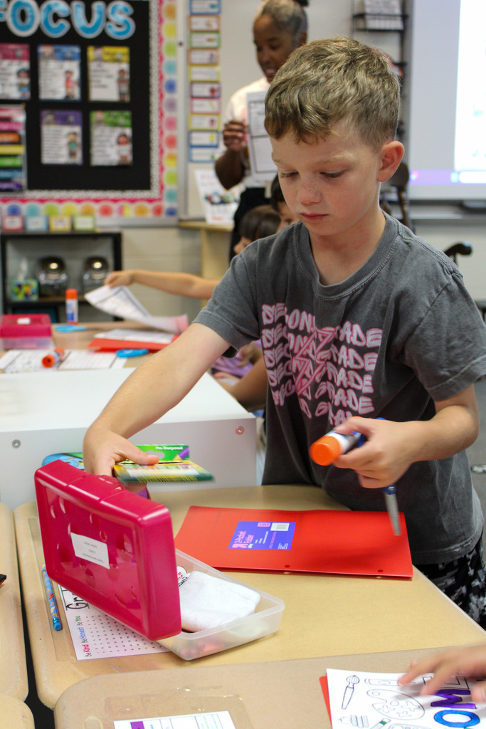 student pulls supplies from box