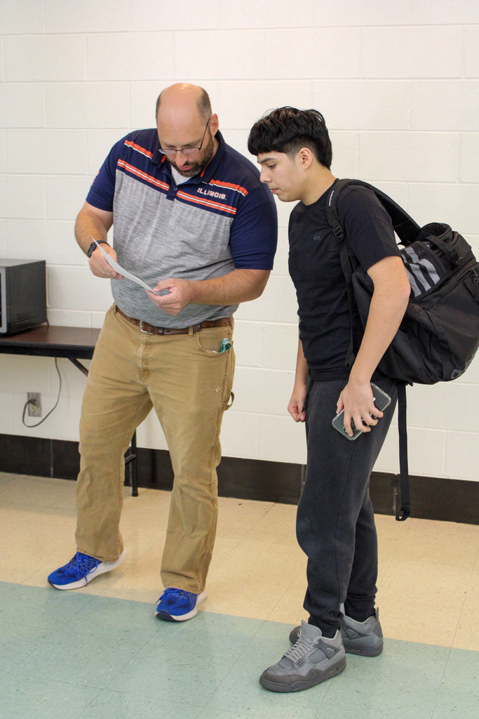 teacher helps students find class