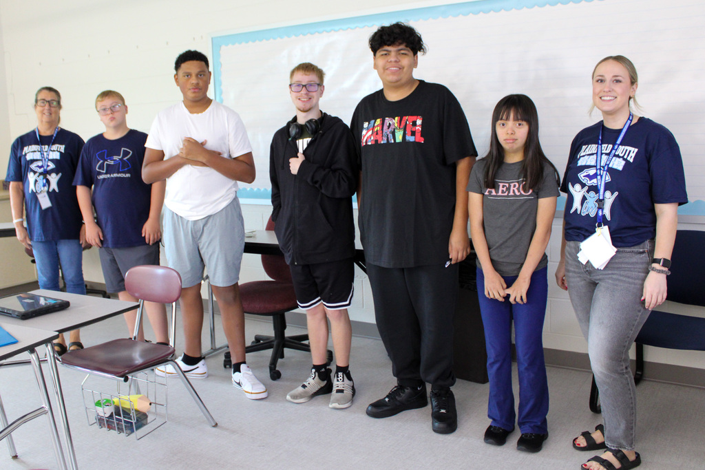group of students stand with teachers on first day of school