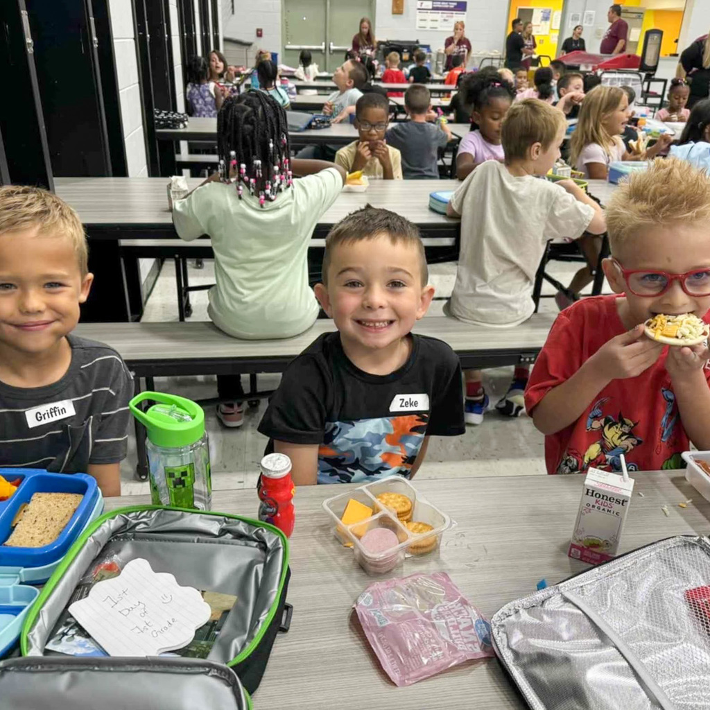 three students eat lunch