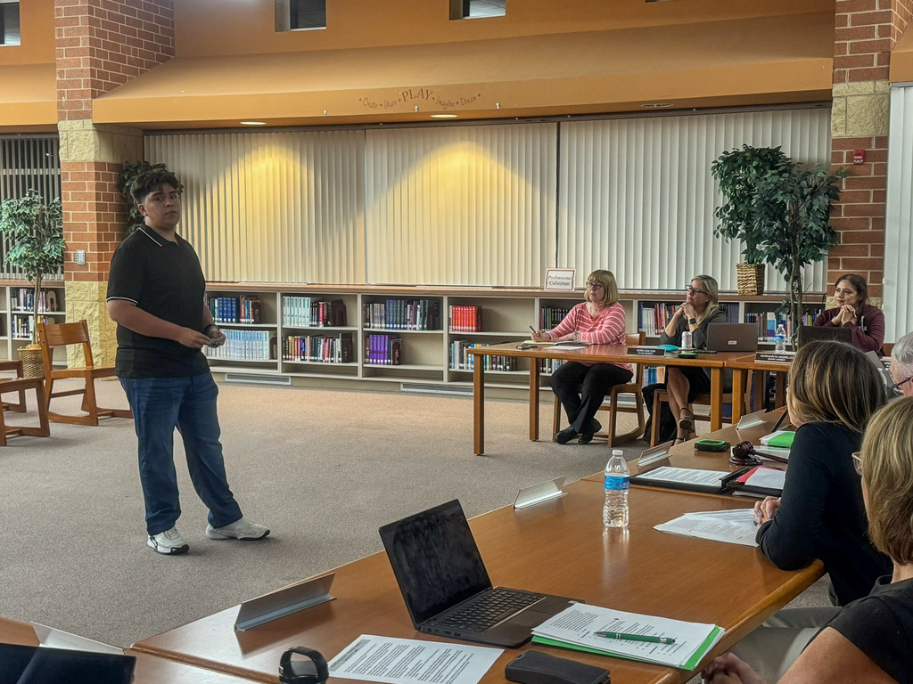 student stands and speaks before the School Board