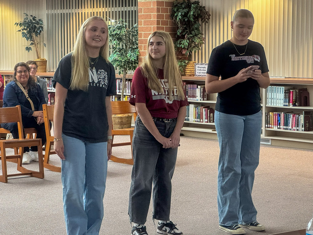 three students speak in front of school board