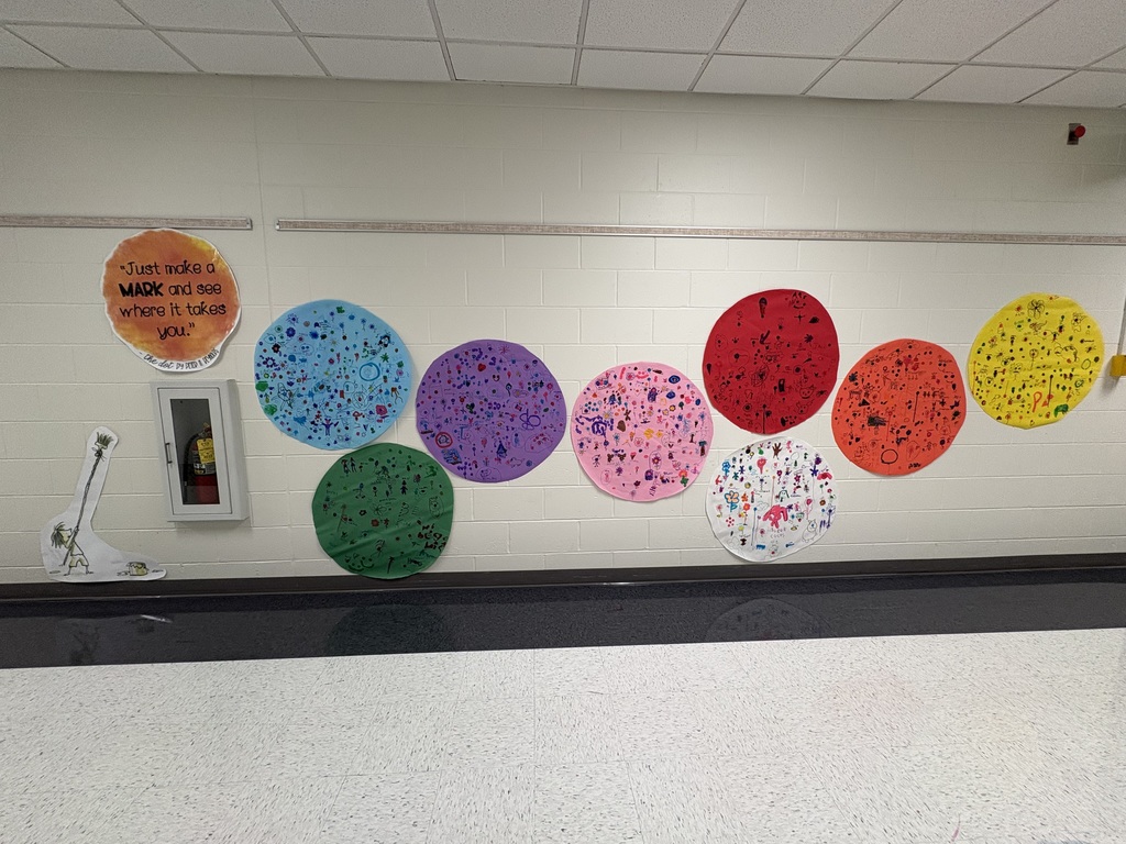 Large dots in a hallway with students art drown inside of them. 