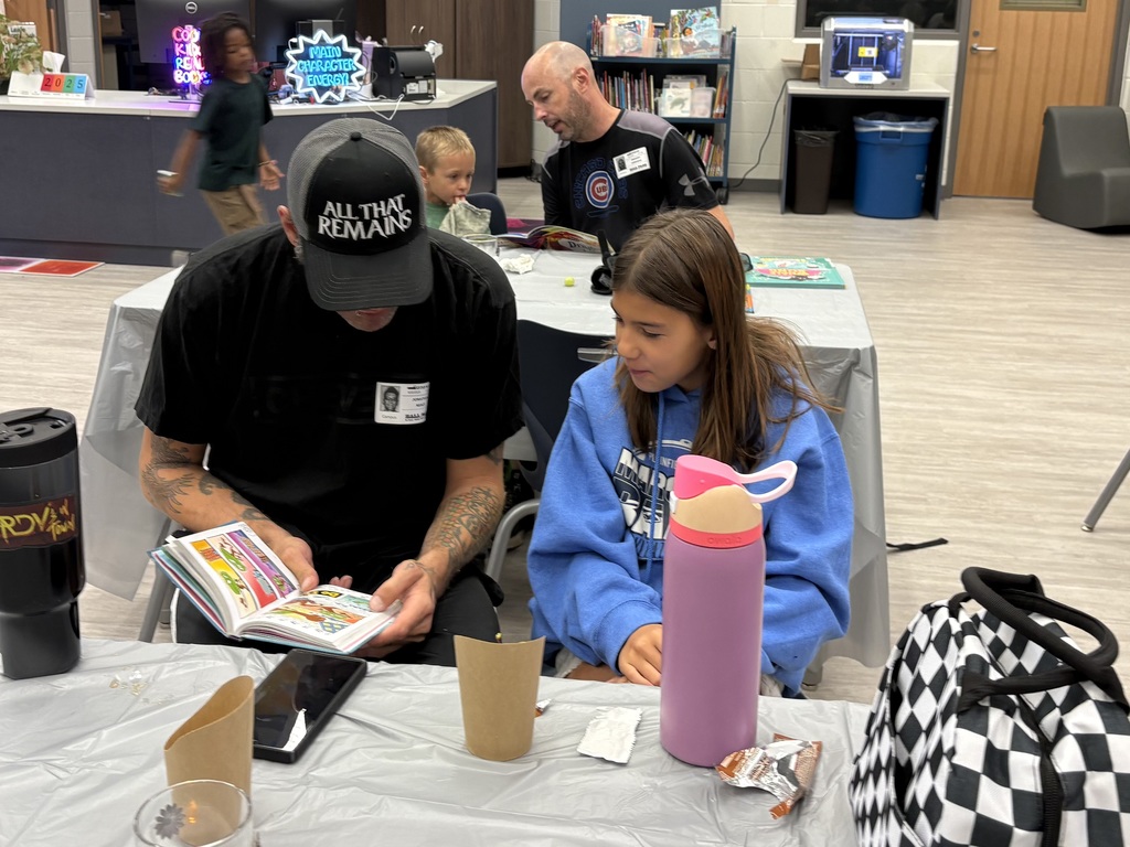 Parents and children reading in a library. 